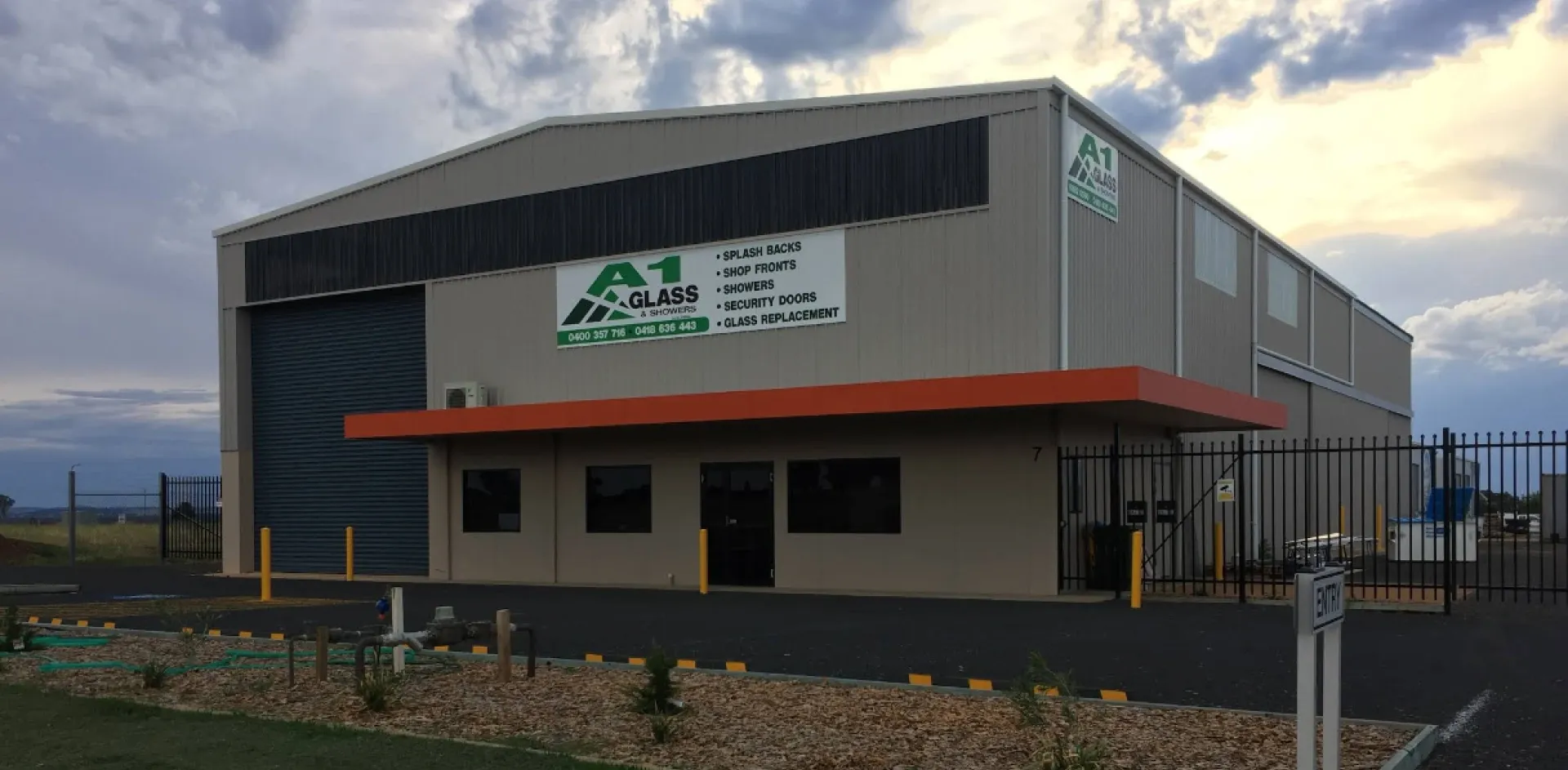 The A1 Glass & Showers workshop and showroom at 7 Capital Drive, Dubbo, with the A1 sign beside the roller door